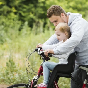 caring-father-holding-daughter-bike